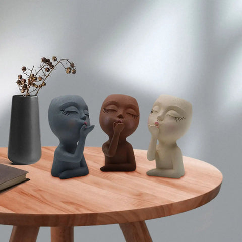 Three silicone girl head planter molds for succulents on a wooden table, part of Two Piece Girl Head Planter Molds For Pots Made From Concrete And Silicone Face Portrait Sculpture Planter For Succulents Indoor Outdoor Home Garden Decor Balcony Patio Yard.