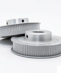 Dead Nuts Accurate Aluminum HTD 3M Timing Belt Pulley Sporting 150 Precision Teeth And Slick Sync Motion Packaged As A Heavy Duty 10 Piece Bundle With Multiple Bore Choices. Close-up view of two aluminum timing belt pulleys.