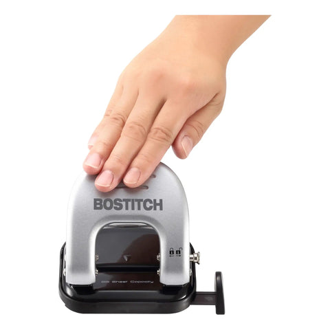 Hand pressing EZ Squeeze Reduced Effort Two Hole Punch For Home Office With No Jam Technology, durable metal construction, compact design