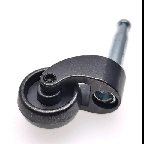 Close-up of a 1-inch vintage black zinc-alloy swivel ball caster with mounting stem