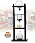 Premium Cold Brew Maker And Ice Coffee Machine With Slow Drip System, 32 Oz capacity, glass pitcher, and wooden stand.