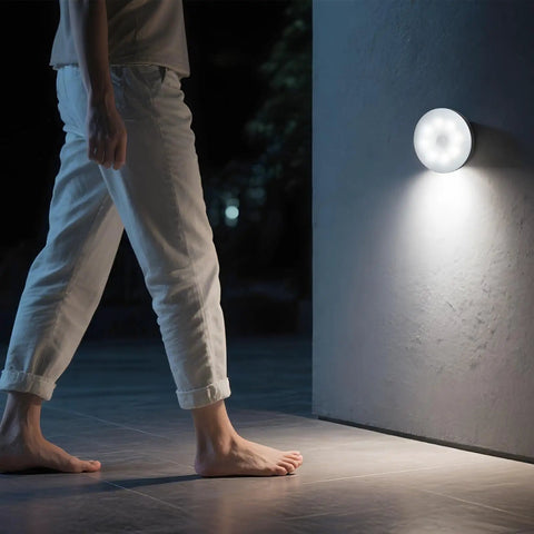 Person walking near installed Rechargeable Magnetic Puck Lights With Motion Sensor, Three Lighting Modes And Dimmable Brightness