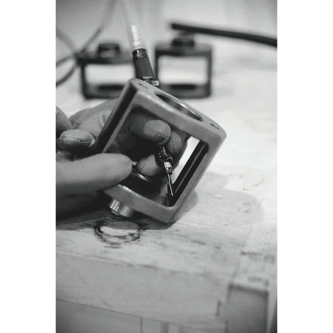 Tough Built 1/8 Inch Pneumatic Air Pencil Die Grinder With Rear Exhaust Quiet Silencer Hose And Rock Solid 60000 Rpm Steel Frame in use, showing details of hand and component.
