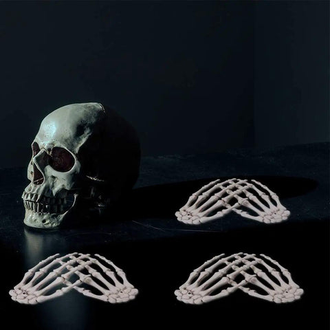 Six Pack Halloween Skeleton Hands Set Realistic Plastic Skeleton Hands for Spooky Decor with skull on dark surface