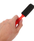 Hand holding a small foam brush for detailed painting in the Premium Top Shelf Paint Roller And Bristle Brush Kit With Heavy Duty No Drip Tray Plus Ultra Soft Sponge Rollers For Smooth Wall Coating And No Sweat Weekend Projects.