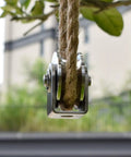 Rock Solid Badass Heavy Duty Groove Wheel Pulley Block Crafted from Bombproof 304 Stainless Steel showing rope and pulley setup outdoors.