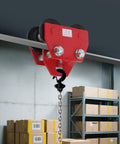 2 Ton Manual I Beam Trolley With Track Rollers Adjustable Beam Width Three Point Five Four Inches To Five Point Five One Inches Heavy Duty Four Four Zero Nine Lbs Load Capacity Sliding Hoist Trolley For Warehouse And Construction installed on beam with visible chain and boxes below in a warehouse setting.