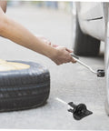 Spare Tire Hold Down Bolt for Trucks and Cars, Easy Install Wheel Bolt Replacement in use during tire change on roadside.