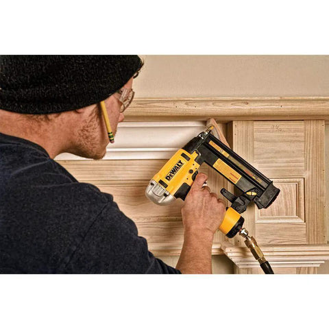 Professional 18 Gauge Brad Nailer With Rear Exhaust Blasts Dust Away Tight Trigger used for trim work on wood paneling.