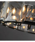 Sleek Modern Black Crystal Ceiling Pendant Light Large Round Hanging Lamp With Polished Stainless Steel Construction close-up view of crystal and light bulbs.