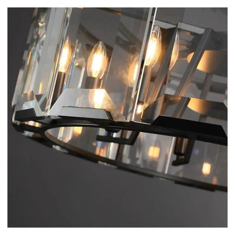 Sleek Modern Black Crystal Ceiling Pendant Light Large Round Hanging Lamp With Polished Stainless Steel Construction close-up view of crystal and light bulbs.