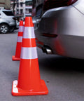 28 Inch Traffic Cones Set Of 12 Jobsite Ready High Visibility Plastic Road Cones PVC Safety Parking Cones next to a car in parking lot