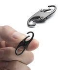 Person holding a Double Small Carabiner Clips For Zipper Replacement And Theft Deterrent, 1.5 inch black clip in hand.