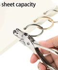 Using a metal handheld one hole punch from 24 Pack Handheld One Hole Punches, No Fuss One Quarter Inch Six Millimeter Metal Paper Puncher For Tags, Tickets, Labels, And Crafts, Eight Sheet Capacity, Portable Office Home School Tool For Quick Piercing on a stack of papers
