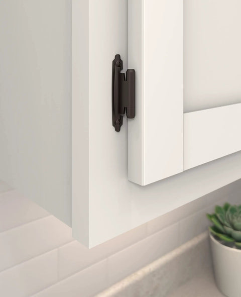 Variable Overlay Self Close Cabinet Hinges Oil Rubbed Bronze installed on a white cabinet door for smooth operation.