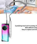 Badass Cordless Electric Nail Drill Machine Packing 30000 Rpm Power And A Massive 2600Mah Battery With Six Interchangeable Grinding Heads on a table with hands being manicured.