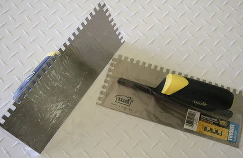 Beast Pro Grade Square Notch Trowel for spreading, stainless steel blade, ergonomic yellow rubber handle, packaging view
