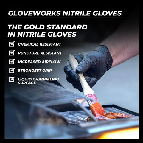 GLOVEWORKS black nitrile disposable glove on hand, holding a basting brush over a grill