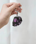 Hand holding a Lightning Pattern Welding Helmet Keychain with durable chain and ring, lightweight acrylic accessory, ideal for welders.