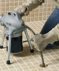 Pro Grade Sectional Drain Cleaning Machine With A Ready To Go Cable Kit For Three Quarter To Four Inch Lines Up To One Hundred Feet in use on a shower drain.