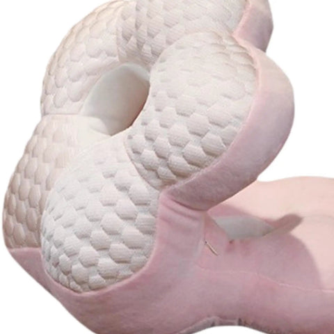 Close-up of Go-To Travel Napping Pillow With Face Cradle, pink ergonomic pillow showing textured surface for comfortable sleep.
