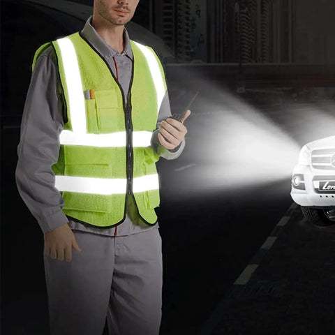 High Visibility Reflective Safety Vest For Men And Women With Pockets Breathable Mesh Fabric Machine Washable Hi Vis Vest ANSI Certified Yellow Loose Fit Large All Day Everyday Work worn by person at night, spotlight shine.