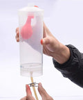 Hands On Physics Lab Kit For Liquid Pressure Depth Relationship, Pendulum Energy Conversion And Pulley System Mastery Through Real World Experiments showing a hand holding a clear container with rubber bulb inside.