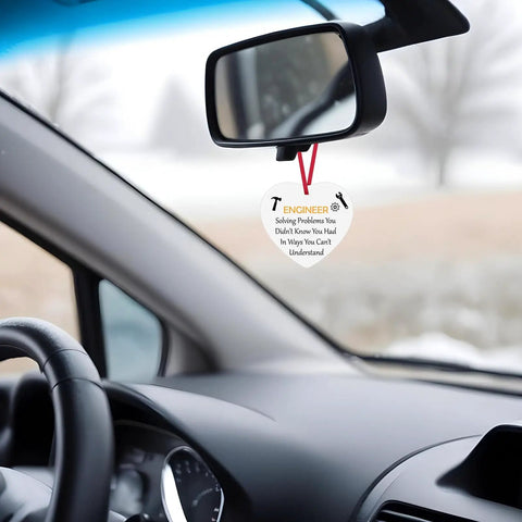 Ceramic engineer ornament hanging in car, Dope Mechanical Engineer Ornament Gift For Engineers And Architects, motivational quote visible.
