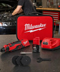 Badass Brushless Cordless Rotary Tool Kit With Whopping Variable Speed Range 5000 To 27500 Rpm And Redlink Intelligence For Cutting Grinding Sanding And Detail Work Built Tough For Hardcore Tradesmen displayed with accessories on a workbench.