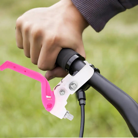 Person using Kids Bike Brake Lever Set on black handlebar, rosy color, 2 to 2.3 cm diameter, replacement plastic levers.