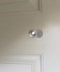 Solid Brass 220 Degree Door Viewer With Rotating Privacy Cover installed on door, silver finish, wide angle view, ideal for security.