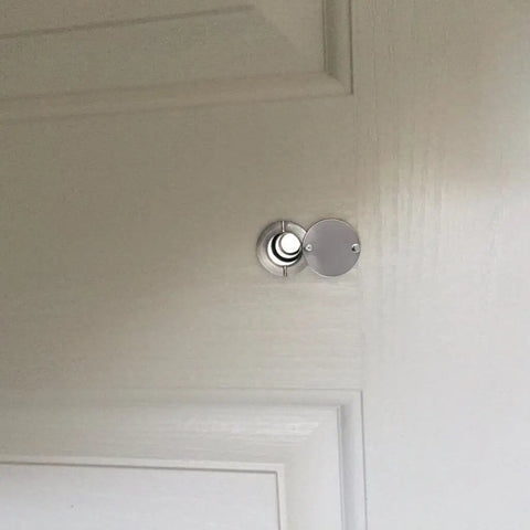 Solid Brass 220 Degree Door Viewer With Rotating Privacy Cover installed on door, silver finish, wide angle view, ideal for security.