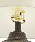 Close-up of Textured Dot Jug Table Lamp With Dark Brown Finish Cast Resin Construction Oatmeal Linen Round Drum Shade detail