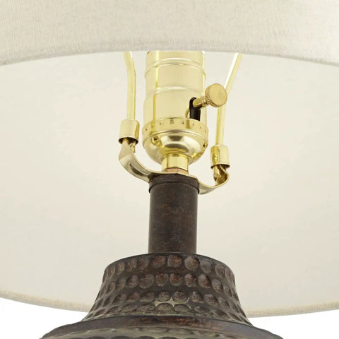 Close-up of Textured Dot Jug Table Lamp With Dark Brown Finish Cast Resin Construction Oatmeal Linen Round Drum Shade detail