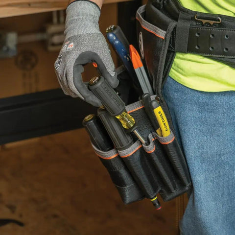 Slotted Screw Holding Screwdriver Set With Three Sixteenth Inch And One Quarter Inch Flat Head Drivers Positive Gripping Action Two Piece Pro Kit For Handyman Projects Great For Stainless Steel Screws And Grab And Go Jobs held by gloved hand in tool belt.