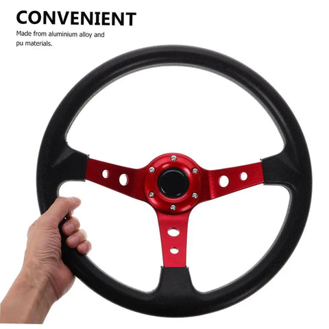 Hand holding a 14 Inch PU Racing Steering Wheel With Horn Button For Drift Go Kart Simulator And Off Road Vehicles Durable Aluminum Alloy Build And Comfortable Grip For Long Drives, showing red aluminum alloy center.