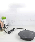 Kickass Smart Touch Cup Warmer Plate 15W Constant Temperature Heating Coaster plugged into outlet with black cord in office setting.