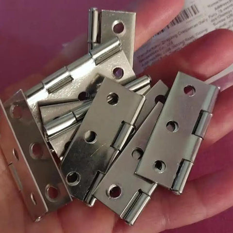 Heavy Duty Stainless Steel Flat Hinges With A Slick Silver Finish 20 Pack in hand showing details and pre-cut slots.