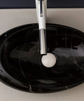 Top Tier Ceramic Vessel Sink For Master Bathroom Vanity Countertops, Badass Artistic Wash Basin With Waterproof Glazed Finish And Hella Easy Wipe Down Cleaning Routine, black oval shape with modern faucet.
