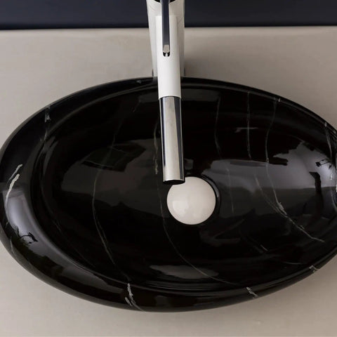 Top Tier Ceramic Vessel Sink For Master Bathroom Vanity Countertops, Badass Artistic Wash Basin With Waterproof Glazed Finish And Hella Easy Wipe Down Cleaning Routine, black oval shape with modern faucet.