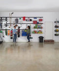 FastTrack 24 Piece Garage Wall Mounted Storage Kit With 6 Rails And 18 Hooks in a garage setup holding various tools.