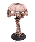 Close-up of Light Up Skeleton Table Lamp With Four Bone Skull Design, LED 3D Skeleton Night Light on resin base, spooky home decor.