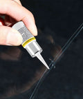 Hand applying Windshield Repair Kit With Nano Resin Fluid For Quick Fix Of Small Chips To Cracks on auto glass surface