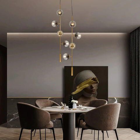 Dining room with Lit Four Light Smoky Gray Glass Globe Pendant Light with Adjustable Cord and Gold Accents, modern art decor.