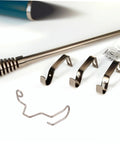 Metal brackets and springs next to a curtain rod, representing Ten Pack Pro Grade Finger Guard Springs For Sewing Machines Hand Safety Shield Needle Guard Easy Install Durable Sewing Machine Accessory For Safe Stitching That Lasts.