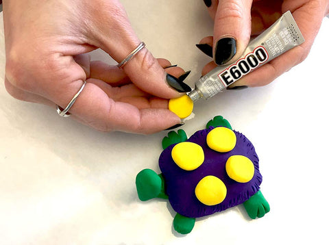 Craft Adhesive 4 Pack 0.18 Oz Tubes With Five Minute Open Time, gluing decoration on purple and yellow turtle model