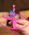 Child holding a pink dragonfly flying disc from the 40 Sets Outdoor Flying Discs With Launchers For Kids