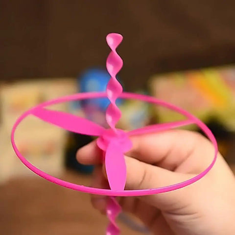 Child holding a pink dragonfly flying disc from the 40 Sets Outdoor Flying Discs With Launchers For Kids