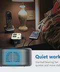 Travel Voltage Converter 220V To 110V with 4 USB Ports on nightstand powering phone and lamp, quiet ball bearing fan feature.