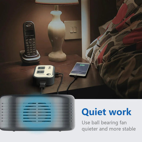 Travel Voltage Converter 220V To 110V with 4 USB Ports on nightstand powering phone and lamp, quiet ball bearing fan feature.